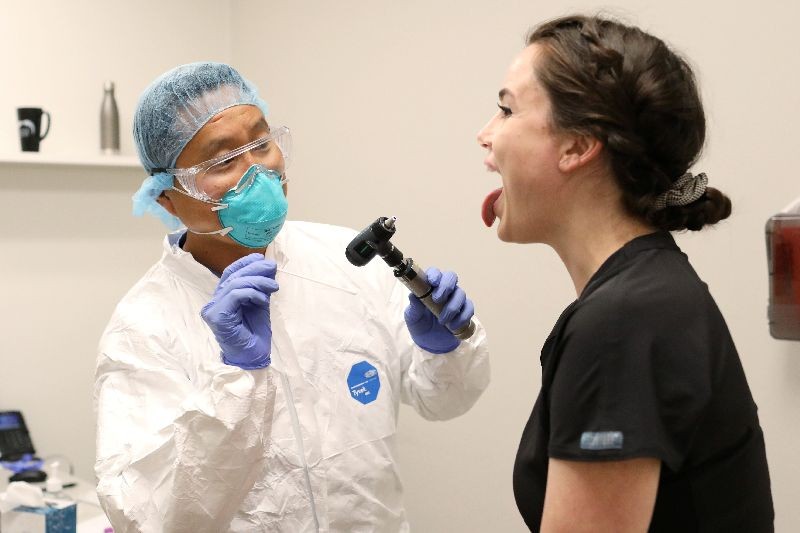Physician John Jones, D.O. tests administrative assistant Morgan Bassin for the coronavirus disease (COVID-19) at One Medical in Scottsdale, Arizona, U.S. June 17, 2020. One Medical employees receive testing every two weeks.   REUTERS/Courtney Pedroza